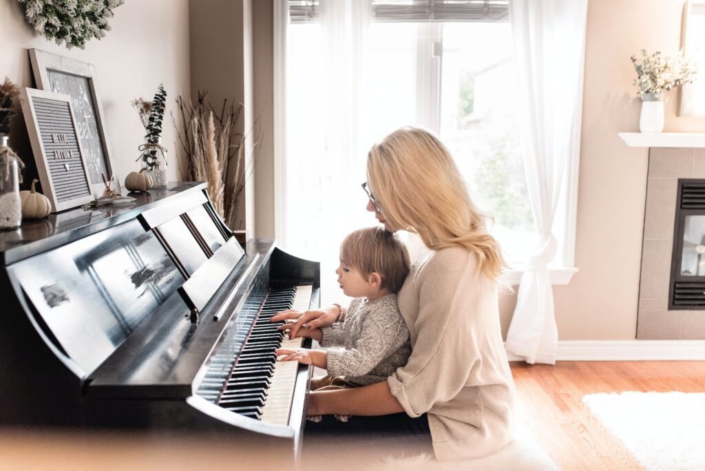 woman and child playing piano | 13 Tips for Motivate Child to Practice Musical Instruments